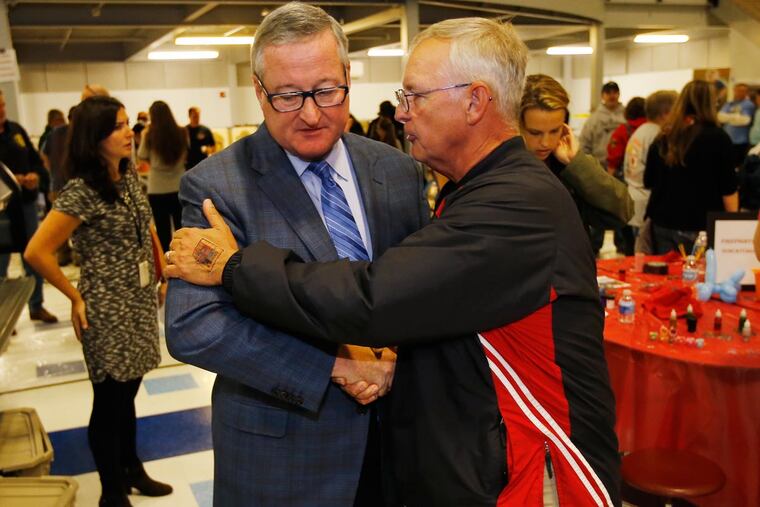 Jim Kenney (left) and Greg Masi, chief of the Second Alarmers, at an event honoring a fallen firefighter.