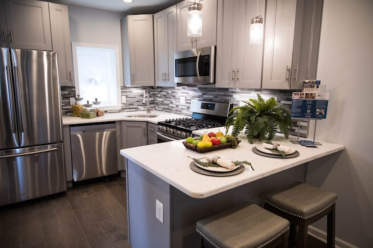 Details such as kitchen stools, plants, place settings, and jars of dried pasta help a house look lived in, yet elegant. This Point Breeze house was staged by Lia Rogers of Reinvention Intention.