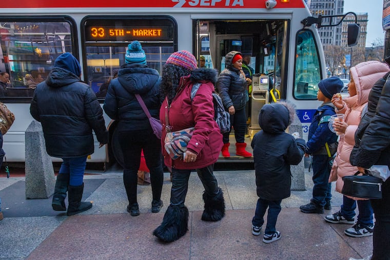 Commuters were covered in their winter coats and hats in Center City on Friday. It will be even colder on Tuesday morning.