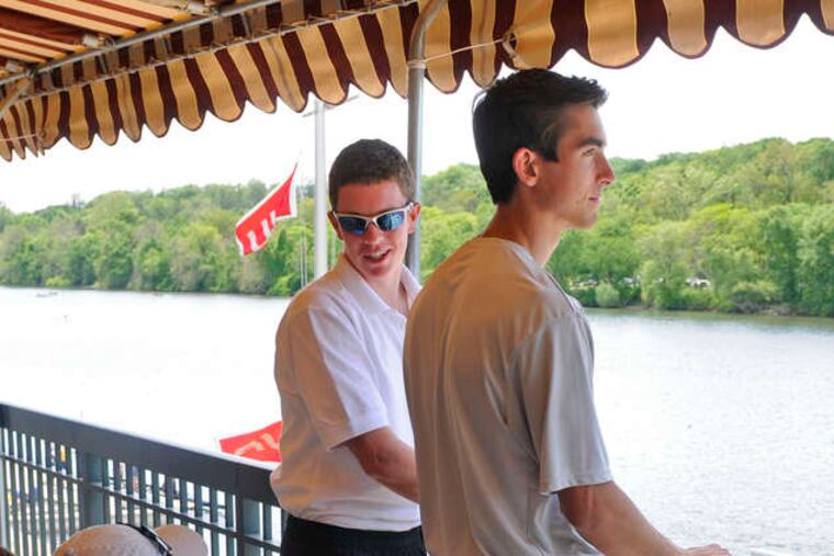 St. Joseph's rowers Brendan Keegans, (standing, left) and Jon Ghaul (right) wait for their race at the boathouse. TOM GRALISH / Staff