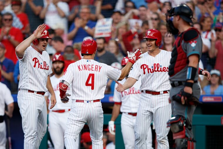Philadelphia Phillies' Jay Bruce, from left, Scott Kingery and J.T. Realmuto celebrate past Arizona Diamondbacks catcher Carson Kelly after Kingery's three-run home run during the second inning of a baseball game, Tuesday, June 11, 2019, in Philadelphia. (AP Photo/Matt Slocum)
