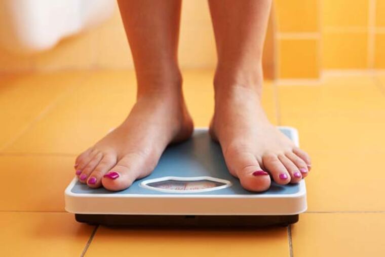 Woman using her scale. (Rostislav Sedlacek/Fotolia/MCT)