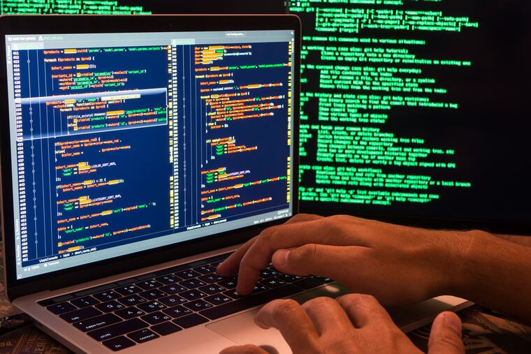 Stock image shows a hacker breaching the secure system in cyberspace, hands on keyboard.