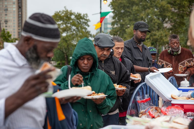 People wait in line for free food from a program called Philly Restart at 19th and the Ben Franklin Parkway on Monday afternoon, Sept. 10, 2018.