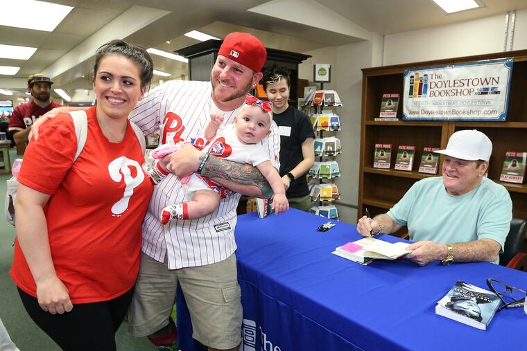 Isabella Rose Wine, 5 months with her parents Rick and Tessa from North Wales pose with Pete Rose at the Doylestown Bookshop signing his new book. Thursday, June 6, 2019