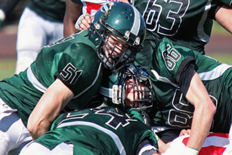 Chris Panichelli (86) helps make a tackle for Bishop Shanahan on Saturday during its game against Coatesville. (Lou Rabito/Staff)