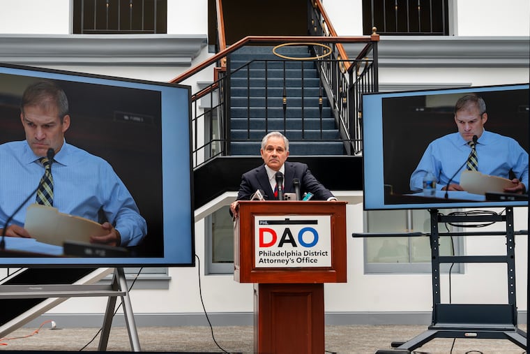 District Attorney Larry Krasner speaks at a news conference, denouncing criticism of his office leveled by Republican members of the House Judiciary Committee and its chairman, Rep. Jim Jordan (on screens).