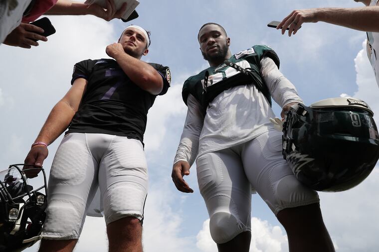 The Ravens' Trace McSorley (left) and Eagles running back Miles Sanders played three seasons together at Penn State. They were reunited at the joint team practice Monday.