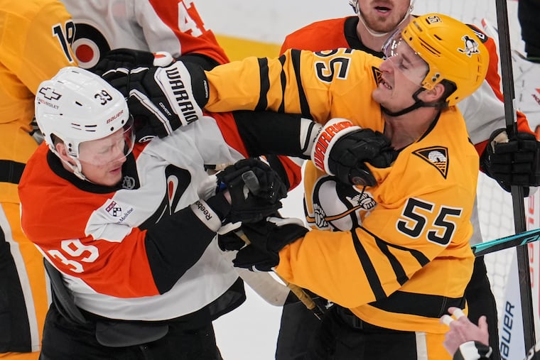 Noel Acciari (55) and the Flyers' Matvei Michkov (39) tangle in front of the net during the first period of Game 2 in the first round of the NHL Stanley Cup playoffs on April 20.