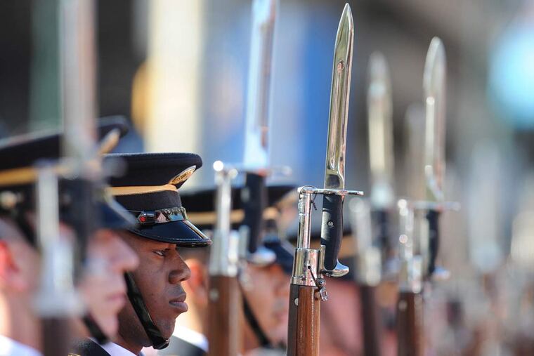 Antoine Allen, a member of the U.S. Army Drill Team, stands at attention during ceremonies in front of the reviewing stand in the 500 block of Market Street during Philadelphia's first Veterans Day Parade on Nov. 8, 2015.