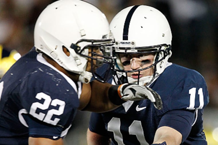 Penn State quarterback Matt McGloin hands off to running back Evan Royster in the first quarter against Michigan. (AP Photo/Gene J. Puskar)