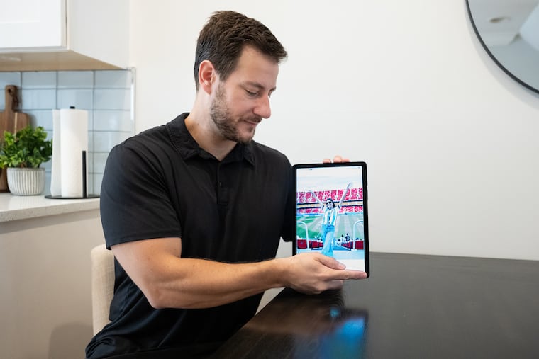 Steven Melchiorre looks at a photograph of his partner, Iliana Lick, displayed on a tablet at their home in the Point Breeze neighborhood of Philadelphia on Tuesday. Lick has remained in ICE custody since her detention at Philadelphia International Airport on July 11.