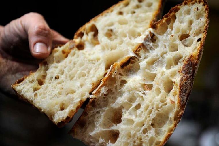 La Colombe co-founder JP Iberti admires the big air holes in a baguette baked by John McGrath.