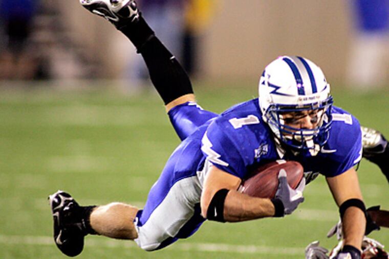 Air Force running back Chad Hall is tripped up by Utah defensive back Eric Weddle. (AP Photo/Jack Dempsey)