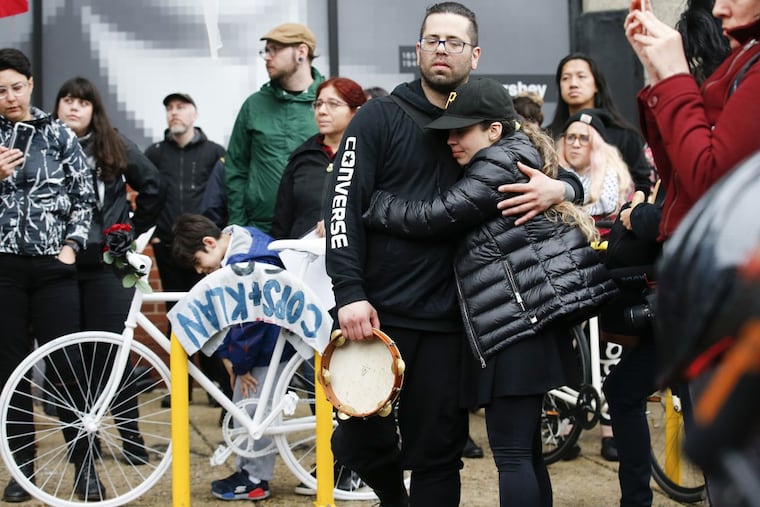 Bryan Avendano (center with tambourine), brother of killed bicyclist Pablo Avendano, is comforted during a Ghost Bike memorial at the corner of 10th and Spring Garden Streets. He was killed while working for a food delivery service.