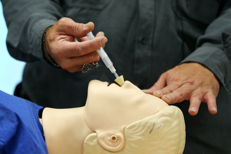 Elvis Rosado, education and outreach coordinator for Prevention Point Philadelphia, demonstrates how to administer naloxone to temporarily stop an opioid overdose on Wednesday, Dec. 13, 2017.