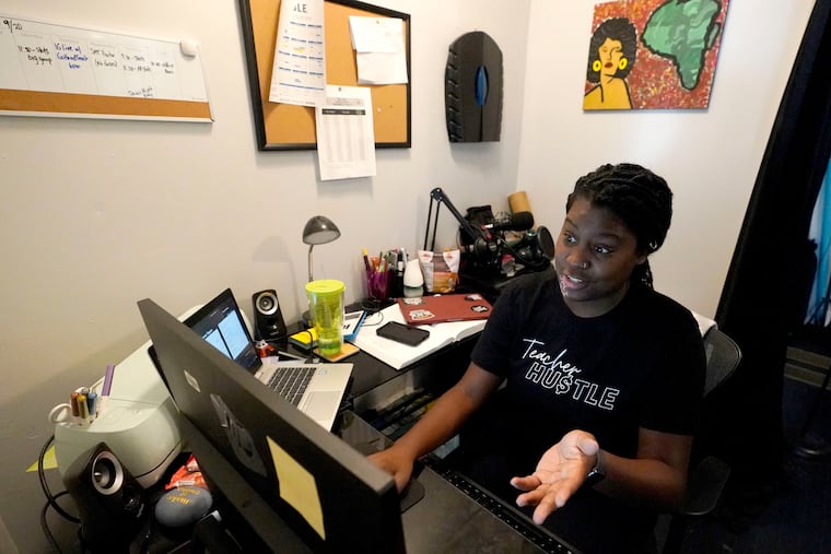 A Chicago charter school teacher, Angela McByrd, works on her laptop to teach remotely from her home in Chicago, Thursday, Sept. 24, 2020. Depending on how long work-from-home practices continue, employers and their employees may be facing some local tax problems. (AP Photo/Nam Y. Huh)