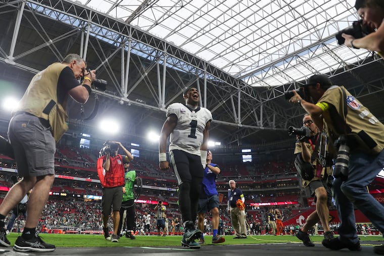 Philadelphia Eagles quarterback Jalen Hurts (1) is surrounded by cameras as he exits the game following a win at State Farm Stadium in Glendale, Ariz. on Sunday.
