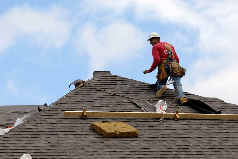 A construction worker finishes a roof in Chicago. Confidence in homebuilders is at its highest in six years.