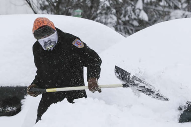 Alex Neff of East Pikeland, Chester County, digs out his two cars on Feb. 13, 2014. STEVEN M. FALK / Staff Photographer