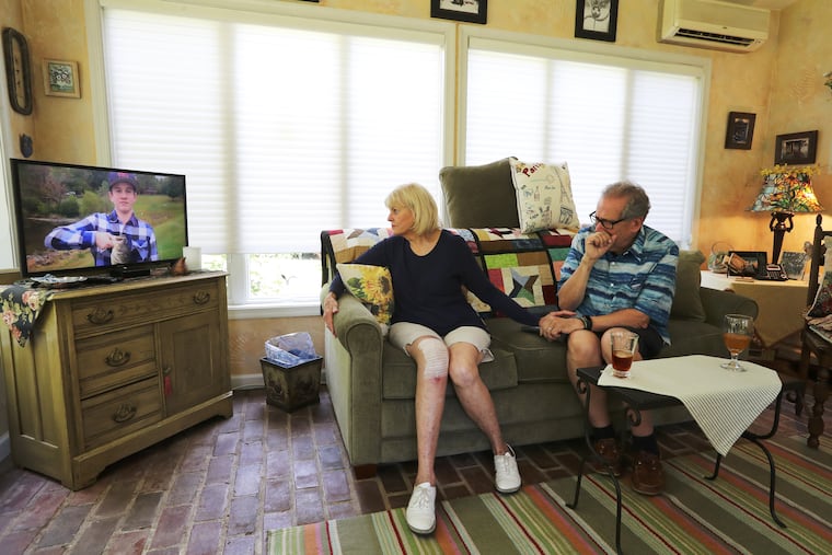 Grandparents Sharon and Rich Patrick, legal guardians of Jimi Patrick watch a memorial video nearing the anniversary of the murders of four young men in Bucks County July of 2017.