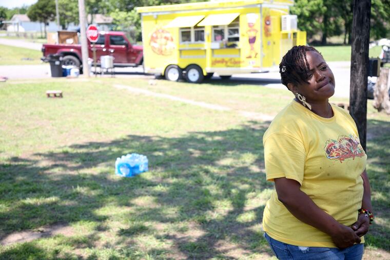 Kountry Queens food truck owner Tiffany Walton talking to media at the scene of a shooting at a Memorial Day event in Taft, Okla., on Sunday. Walton was working at her food truck when the incident happened.