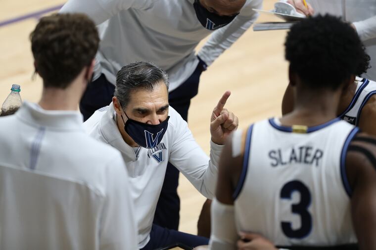 Coach Jay Wright of Villanova huddles his team against St. Joseph’s on Dec. 19.