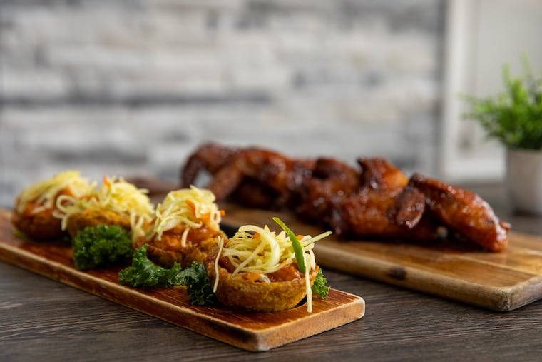 Plantain cups with shrimp and fried chicken wings, glazed with mango flavored Rhum Barbancourt at Gou Saturday, Oct. 11, 2025, in Philadelphia.