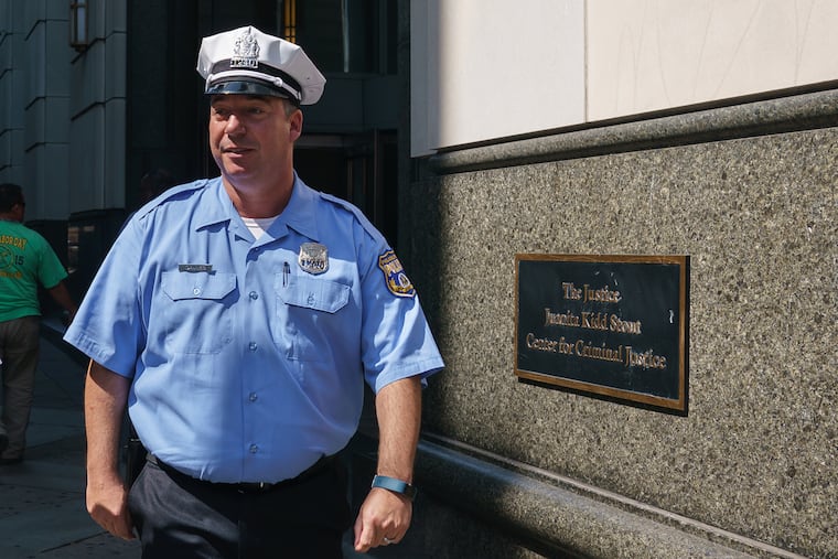 In a file photo, Officer Edward Davies exits the Stout Center for Criminal Justice during jury selection on Wednesday, Sept. 11, 2019, for the retrial of Eric Torres, accused of shooting and wounding Davies during a struggle inside a Feltonville bodega in 2013.