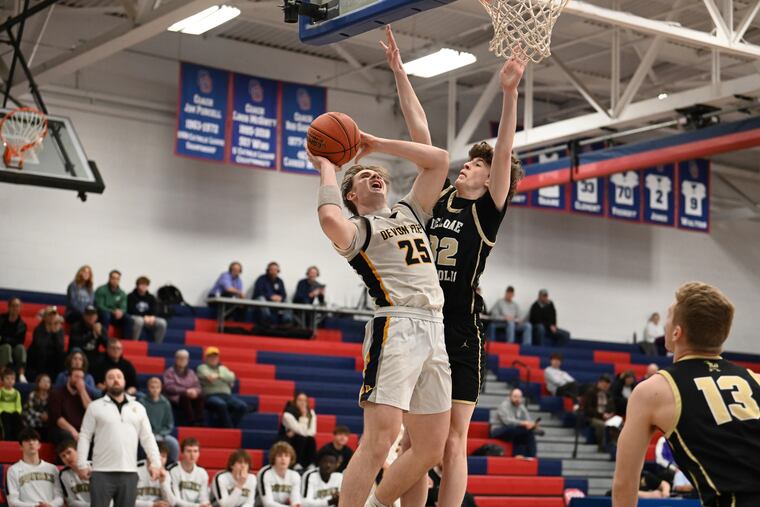 Devon Prep junior Zane Conlon (left) goes up for a shot against Delone Catholic in the PIAA playoffs March 9.