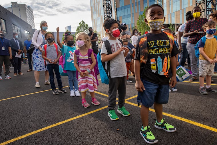 Anthony Turner, 5, (right) waits to start kindergarten at Powel Elementary school in West Philadelphia. Behind Anthony is classmate Hussain Alshanbari, 5. Powel and SLAMS started in a new building Tuesday, the first day of school for 120,000 Philadelphia School District students.