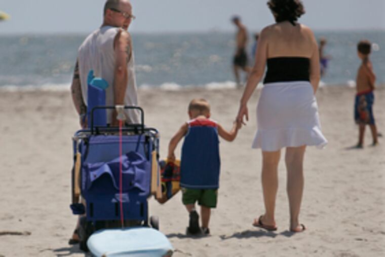 Jack Rehfuss and family head for Avalon's beach. Investigators were trying to trace the material that washed ashore Saturday.