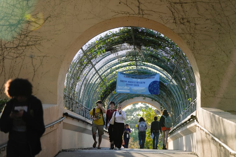 Students cross a bridge on the campus of the New College of Florida in Sarasota, Fla. in February 2023.