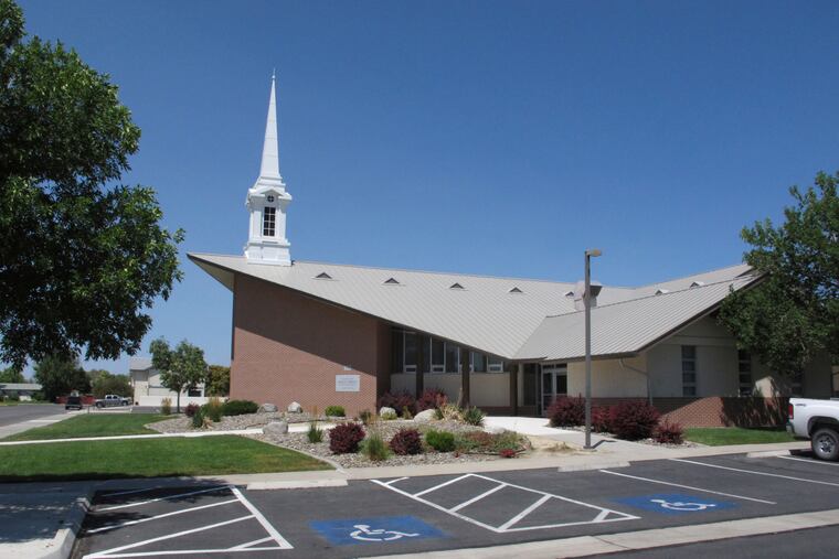 FILE - In this July 23, 2018, file photo, The Church of Jesus Christ of Latter-day Saints church where a longtime rural Nevada volunteer firefighter was fatally shot during a Sunday services is shown in Fallon, Nev., about 60 miles east of Reno. The Church of Jesus Christ of Latter-day Saints has hardened its rules against bringing guns to church by tweaking the policy to say it is "prohibited" for anyone except police officers. Daniel Woodruff, a spokesman for the Utah-based faith, on Monday, August 26, 2019 confirmed the change to a church policy handbook.(AP Photo/Scott Sonner, File)