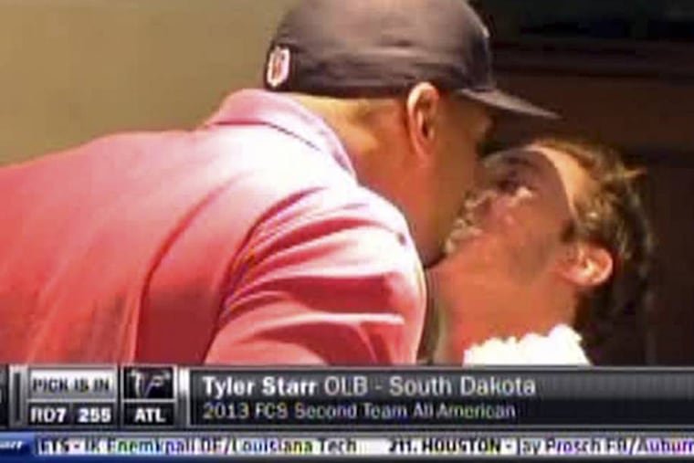 In this image taken from video, Missouri defensive end Michael Sam, left, gets a kiss from his boyfriend at a draft party in San Diego before he was selected in the seventh round, 249th overall, by the St. Louis Rams in the NFL draft Saturday, May 10, 2014. The Southeastern Conference defensive player of the year last season came out as gay in media interviews this year. (AP Photo/ESPN)