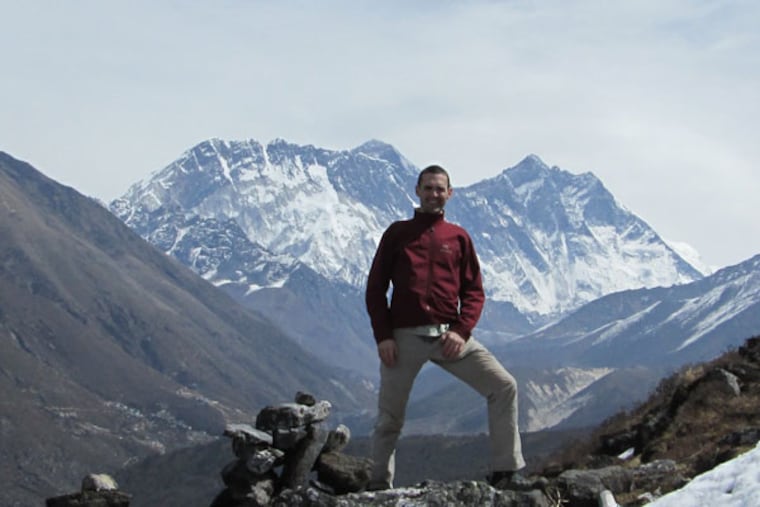 Andrew Towne stood on a ridge above the Tengboche monastery. Everest is poking out from behind Nuptse in the background (Photo courtesy of Andrew Towne).