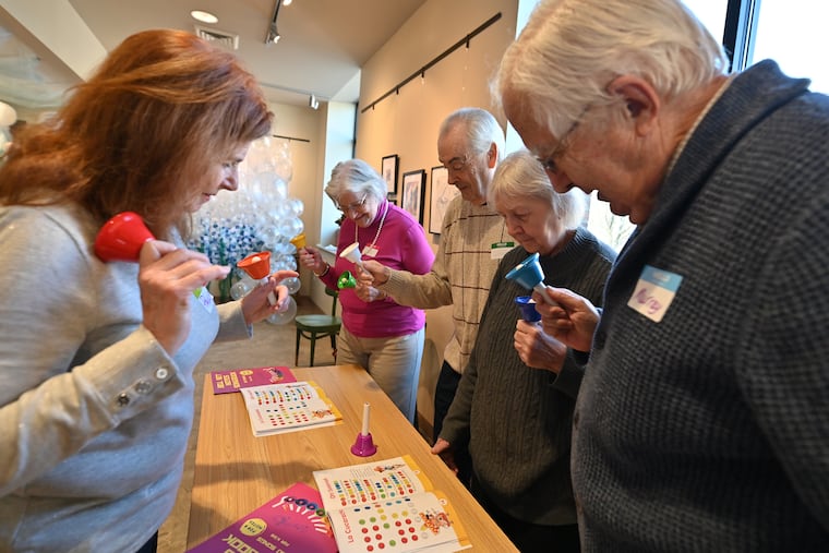 Paula Baillie (from left) leads Sharon Hannamaker, Joe Edwards, Barb Edwards, and Murray Small as they play the bells at The Gathering Place, a memory cafe in Clarks Summit, Pa. (Aimee Dilger/WVIA News)