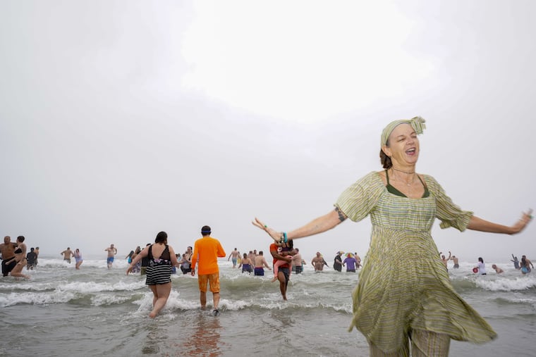 People run into The Atlantic Ocean kicking off the polar plunge in Atlantic City, NJ., on January 1, 2021. Participants brave the cold to jump in The Atlantic Ocean for this annual event.
