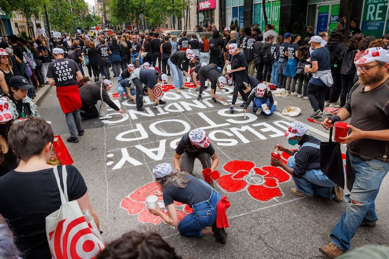 A message is painted on the street in front of Israeli Corporation for Israel that reads, “Jews Say: Stop Funding Genocide.”