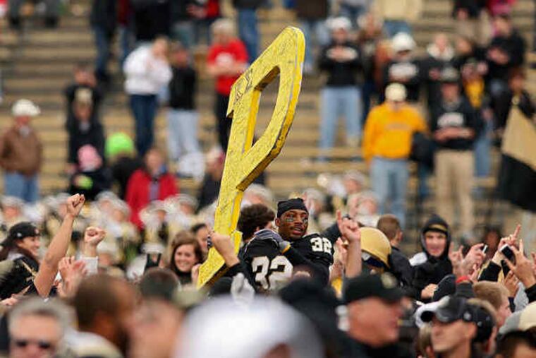 Purdue players and fans dance on the field after the Boilermakers' 26-18 upset of No. 7 Ohio State in West Lafayette, Ind. It was Purdue's first win over the Buckeyes since 2004.