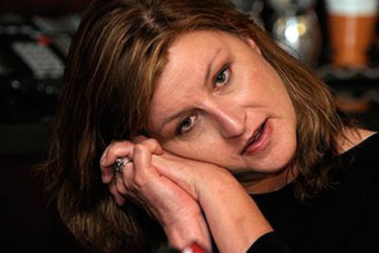 Ginger McGuire, a Ferndale, Mich. woman who fell asleep on a plane and was left aboard for four hours after it landed in Philadelphia, demonstrates how she was sleeping, during a press conference at lawyer Geoffrey Fieger's, left, Southfield, Mich. office on Thursday May 27, 2010. Fieger announced a lawsuit against the airlines on Thursday on behalf of McGuire. The Detroit News reports that her four-count lawsuit filed in Wayne Circuit Court alleges negligence, false imprisonment, emotional distress and breech of contract against the two airlines, Trans States which works in conjunction with United Airlines, leaving her locked on an airplane for four hours after it landed. (AP Photo/The Detroit News, Brandy Baker)