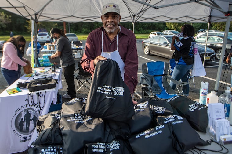 Dreams of Tomorrow organization president Bobby Harris hands out 2020 Census information during a community gathering Sept. 18 in Winslow, Camden County. Communities across the region are scrambling to make sure their residents are counted ahead of a Sept. 30 deadline, although a federal judge's ruling may mean the population count gets one additional month.