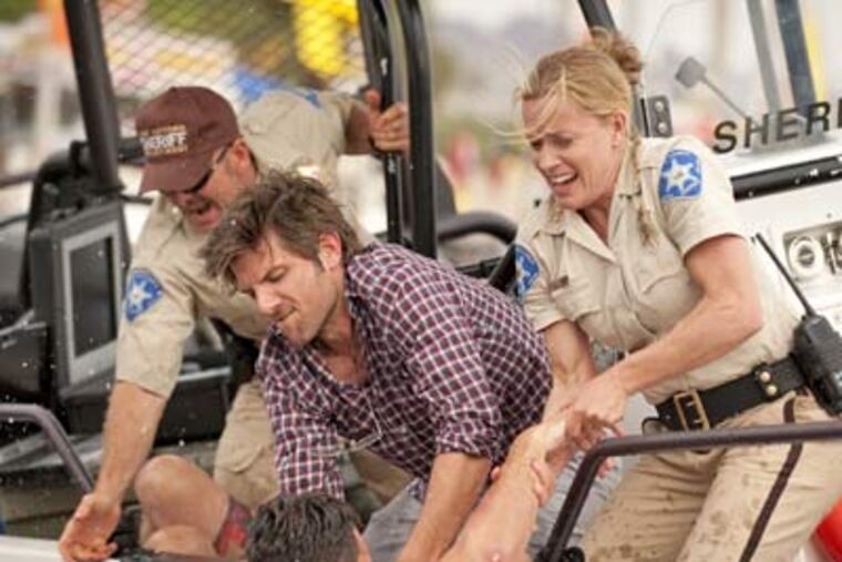 Adam Scott (center) and Elisabeth Shue star in Alexandre Aja's "Piranha in 3D." (Gene Page / Dimension Films)