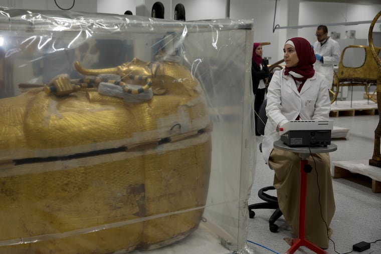 The gold-covered sarcophagus of King Tutankhamun is encased in a tent for restoration procedures at the conservation center of the the Grand Egyptian Museum in Giza, near Cairo, Egypt, Sunday, Aug. 4, 2019. Antiquities Minister Khaled el-Anany told reporters Sunday that work on the outermost coffin, made of wood and gilded with gold, will take at least eight months. He said that’s because “it was never restored” since 1922, when British archaeologist Howard Carter discovered the 3,000-year-old tomb and the treasures it held. (AP Photo/Maya Alleruzzo)