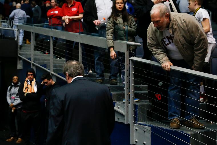 Fran Dunphy walks off the court past fans after the loss to Belmont.