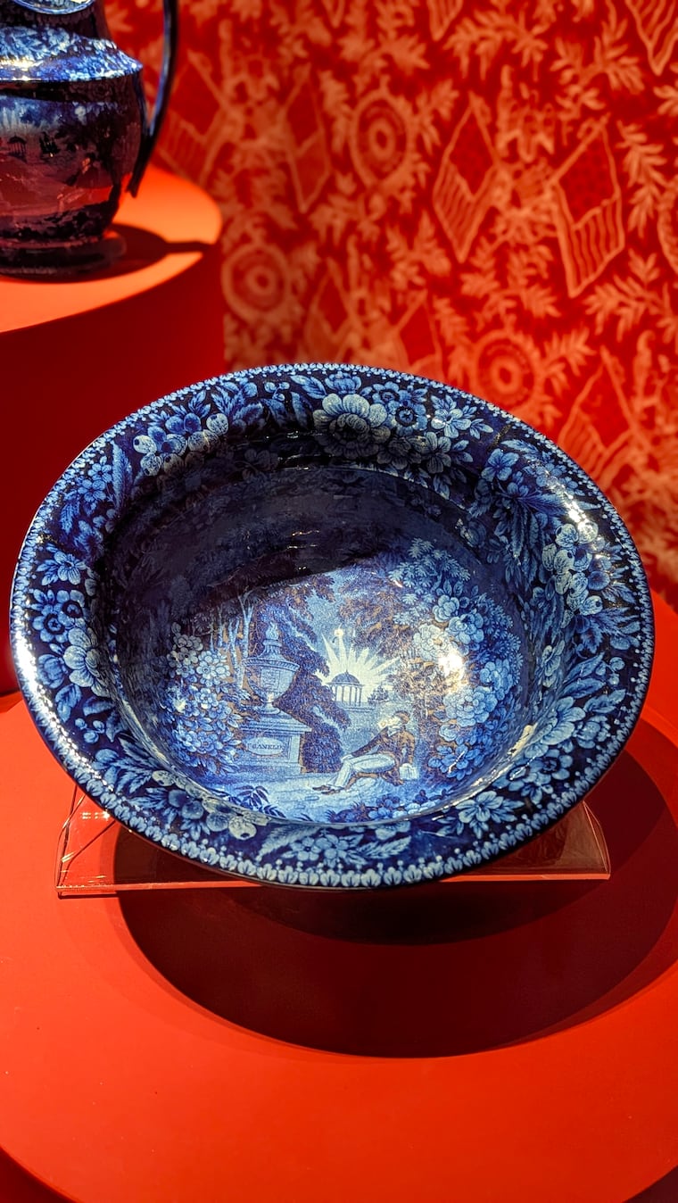 Produced in a factory in Burslem, Staffordshire, a tea service set in blue and white earthenware shows Marquis de Lafayette sitting by Benjamin Franklin's grave. This imaginary scene appeared on plates and other items manufactured to commemorate Lafayette's return to the U.S. in 1824. From the “Lafayette between France and America: History and Legend” show at Musée des Archives Nationales, Paris.