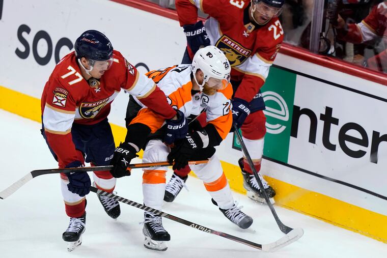 Florida's Frank Vatrano (77) and Carter Verhaeghe pursue the puck with the Flyers' Claude Giroux during the second period.