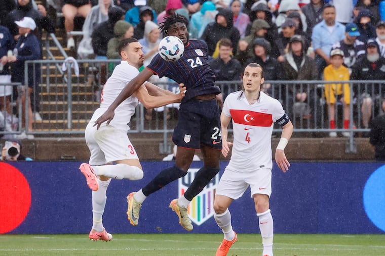 U.S. striker Patrick Agyemang (center) leaps for the ball between Turkey's Merih Demiral (left) and Söyüncü Çaglar (right) during the first half.