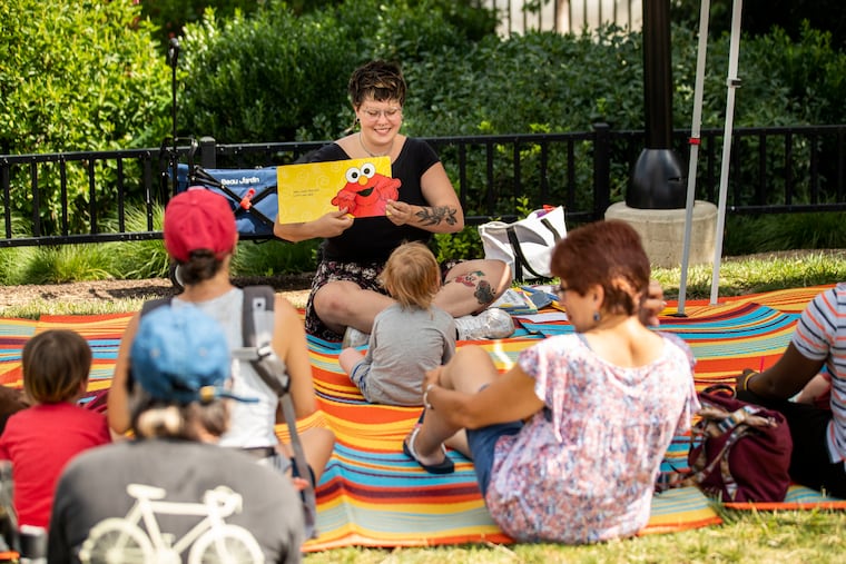 Librarian Rachel Hludzinski leads story time in the park behind the South Philadelphia Library in Philadelphia on July 6. The city is struggling to fill vacancies leaving many departments like the Free Library understaffed.