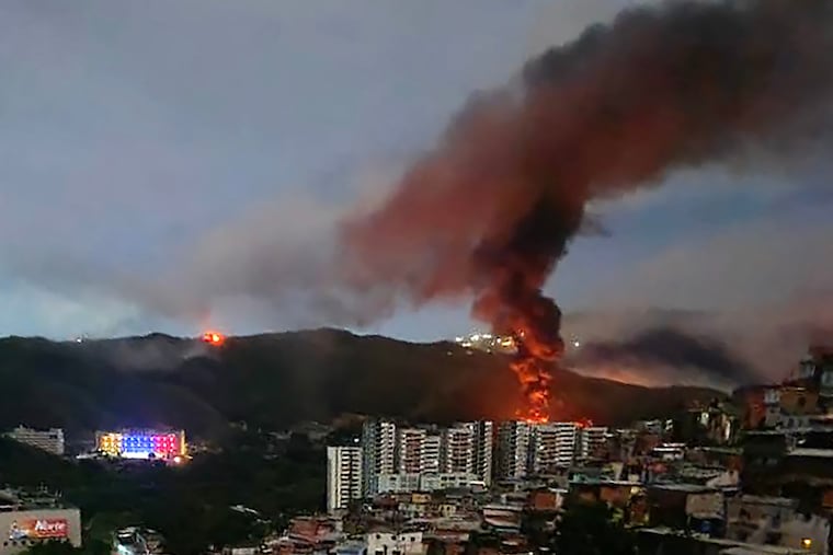 Fire at Fuerte Tiuna, Venezuela's largest military complex, is seen from a distance after a series of explosions in Caracas on Jan. 3. The United States military was behind a series of strikes against the Venezuelan capital Caracas on Saturday.